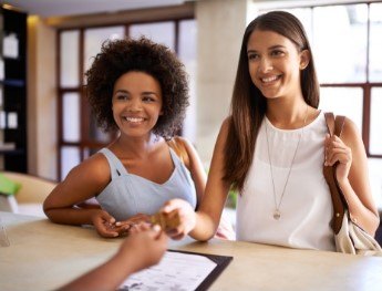 patients smiling at receptionist desk in Orlando